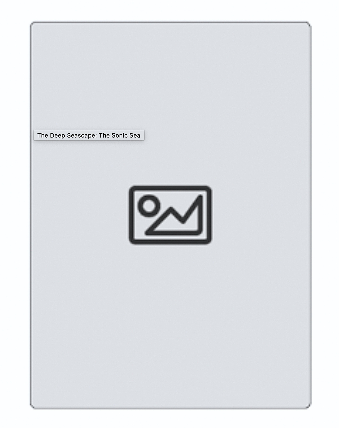 Seascape with a low rocky shoreline in foreground and a high cliff at left with three schooners just visible on water, at middleground, under an overcast sky.