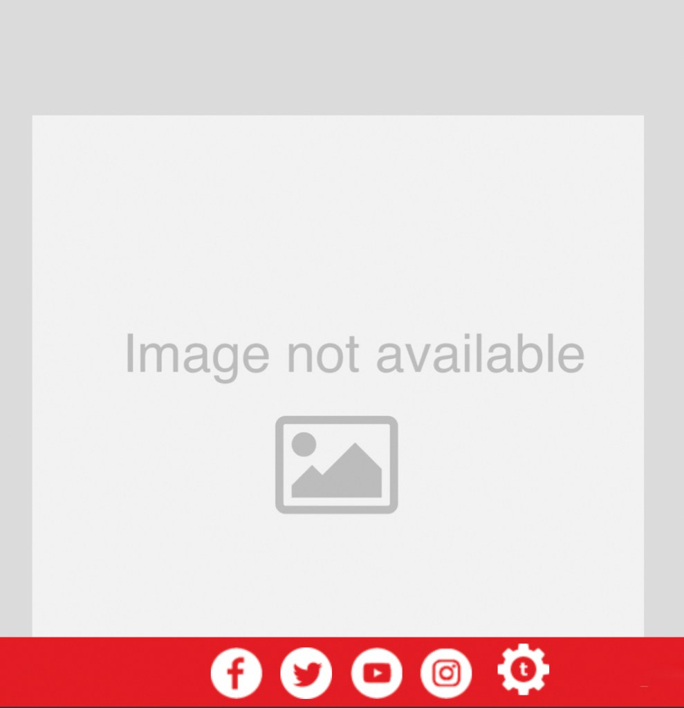 An impressionistic rendering of a woman in a blue skirt and a dark top sitting on a patio at a table under a canopy overlooking a seascape. A silhouetted figure in a hat loom in the background, confronting the viewer. 